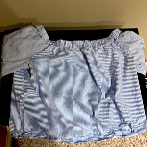 It’s a blue and white striped off the shoulder shirt.